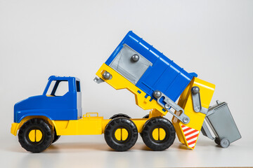 Multi-colored plastic children's toy cars on a white background.