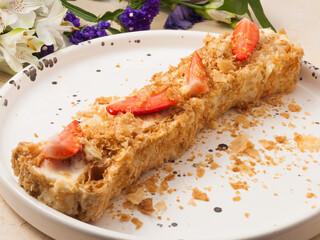 Napoleon cake with strawberries. Unusual serving in a restaurant