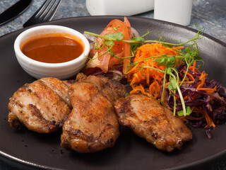 grilled chicken thigh with tomato sauce and vegetables