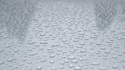 Raindrops on the gray sheet. Two shadows on the background.
