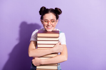 Photo of young excited girl happy positive smile hug books student isolated over violet color...