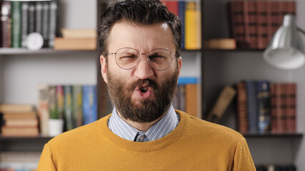 Man disgust, abomination, FU, auch emotion. Bearded male teacher or businessman with glasses...