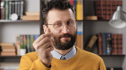 Man money gesture emotion. Bearded male teacher or businessman with glasses looking at camera and shows hand gesture Give me money