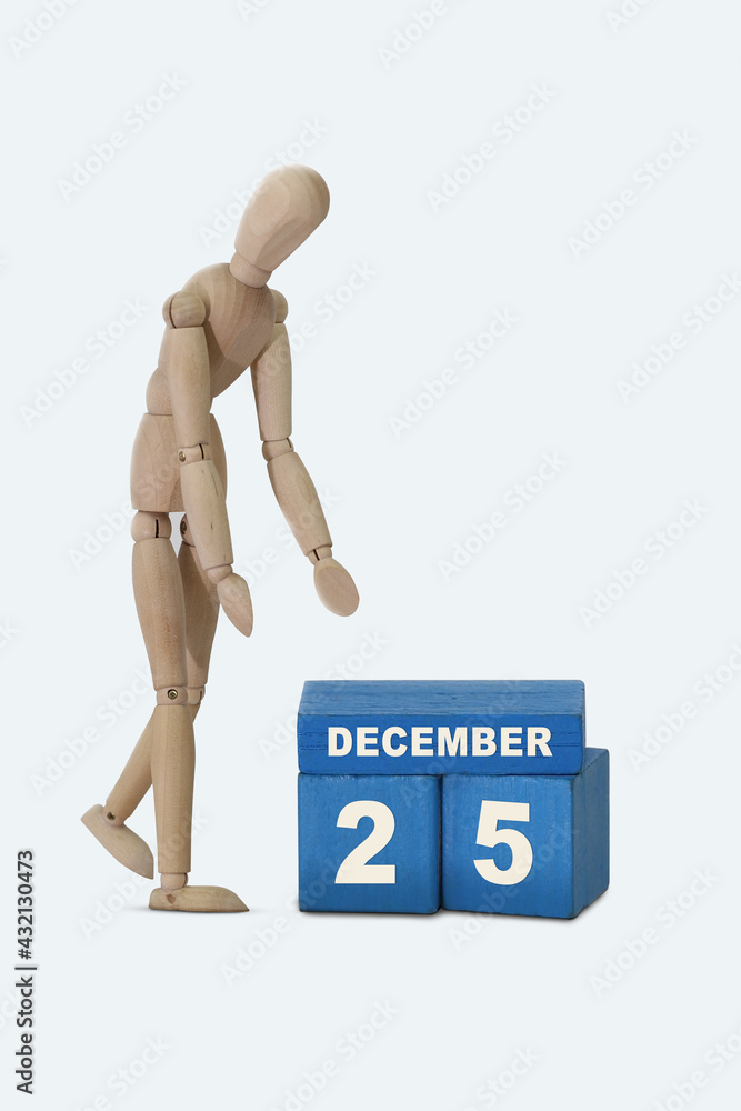 Wall mural day of the month 25 december calendar . a calendar date on blue cubes and a wooden man standing next