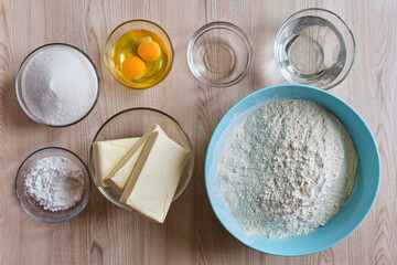 Basic food cooking ingredients around on wooden table.
