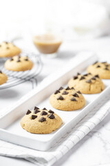 Delicious Whole Wheat Chocolate Chip Cookies set on white cafe table.