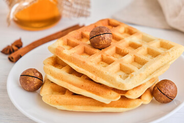 Stack of Belgian waffles on a white plate.