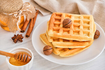 Stack of Belgian waffles on a white plate.