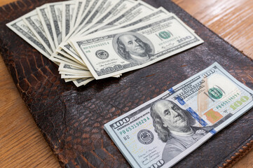 Background with cash money american hundred dollar bills, laptop, phone and docs. Flat lay. Top view