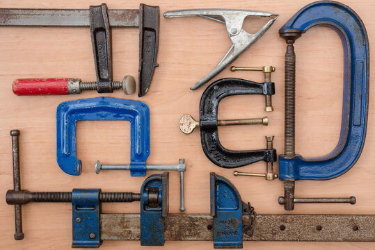 various woodworking clamps used in joinery manufacturing. Top down view from above.