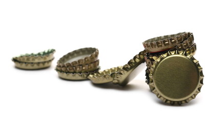 Metal beer bottle caps pile isolated on white background