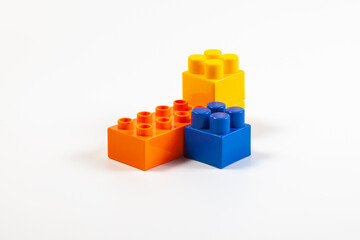 Multicolored elements of the children's constructor on a white background