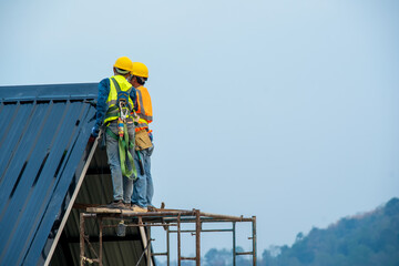 Construction worker wearing safety harness belt during working at high place,New House Construction,Roofing Job.