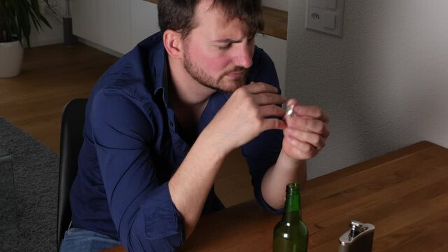 Caucasian young drunk husband pulls off wedding ring, cheating concept.