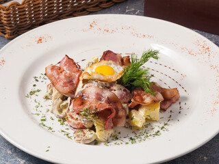 tasty salad with fried bacon, vegetables and egg