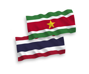Flags of Republic of Suriname and Thailand on a white background