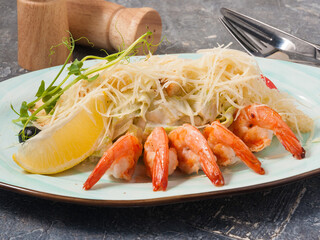 tasty Caesar with shrimp in a restaurant on a gray background