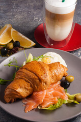 croissant with smoked salmon and a latte. Concept: Breakfast