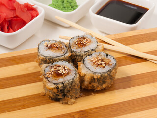 hot sushi rolls with eel on a wooden Board