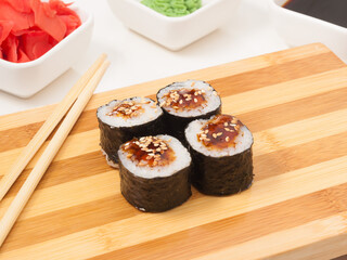sushi roll with eel in seaweed nori on a wooden Board