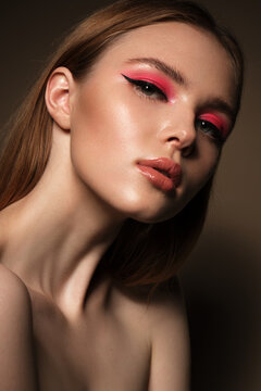 Portrait of a beautiful woman with pink creative make up. Beauty face