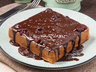 Belgian waffle with chocolate and cherries. Concept: Breakfast