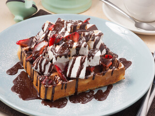 Belgian waffle with strawberries, chocolate and marshmallows