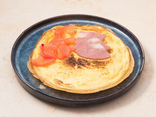 omelet with ham and tomatoes. Concept: Breakfast