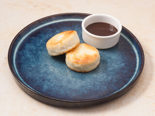 Cottage cheese pancakes with a chocolate topping. Concept: Breakfast