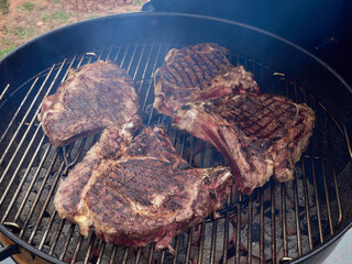 Cowboy steak grilled. Ribeye steak on the bone on the grill grate.