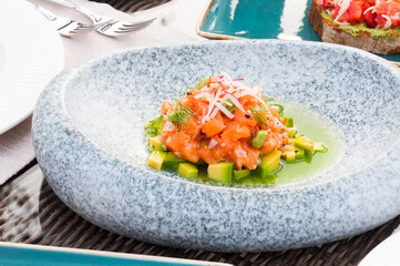 salmon tartare with avocado in the restaurant