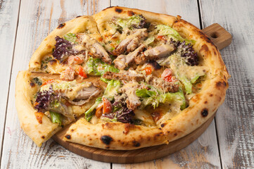 pizza with chicken, lettuce, cherry tomatoes and Parmesan