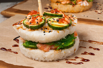 Onigirazu sushi with salmon, cucumber, Chuka seaweed, red caviar
