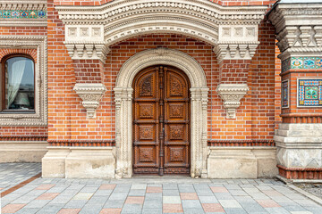 Arched carved wooden door in a beautiful old merchant's house