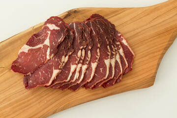 Sliced ​​fresh bacon on wood background.