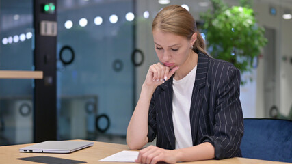 Upset Young Businesswoman Trying to Write on Paper in Office 