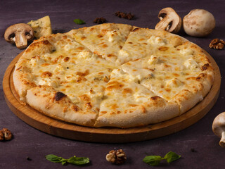 Pizza quattro fromaggi on a wooden board