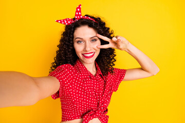 Photo of cool optimistic brunette hair lady do selfie show v-sign wear red top band isolated on yellow color background