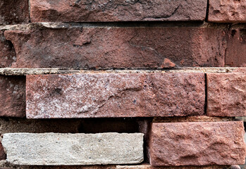 Brick background, textured brick in close-up, red color, brick wall with shadows