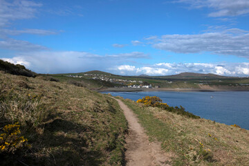 Fototapeta na wymiar LLyn Peninsula coastal path in Wales. With the village of Aberdaron in the background