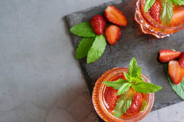 Fototapeta na wymiar Refreshing summer drink with strawberry and mint
