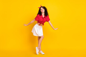 Full size photo of cute optimistic brunette hair lady dance wear red top skirt sneakers isolated on...