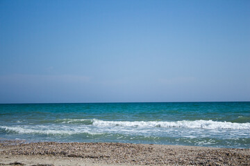 The beach of the Black sea. empty sandy beach with seashells. Blue sky