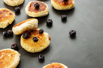 Cottage cheese pancakes with blueberries close-up, with place for text