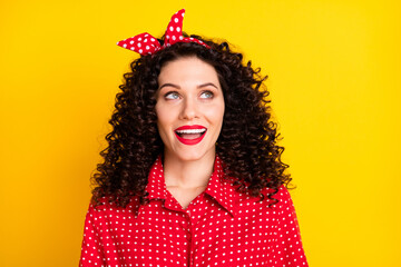 Photo of impressed nice brunette lady look empty space wear shirt band isolated on yellow color background
