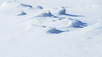 Fototapeta na wymiar shadows and textures on white snow in winter