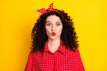 Portrait of nice optimistic brunette curly hair lady blow kiss wear red band shirt isolated on...