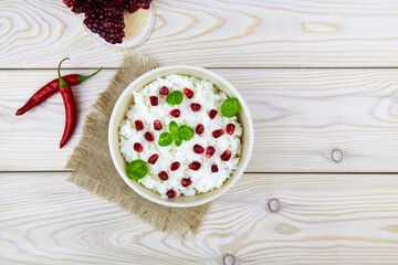 Curd rice. A popular dish from South India with rice, yogurt, spices and pomegranate. Top view. 