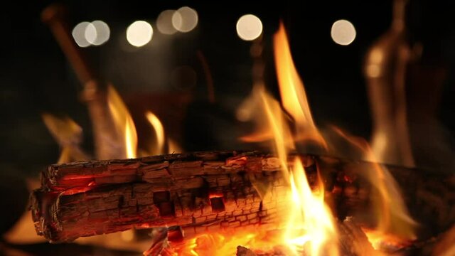 Bonfire with blurred arabic coffee pot and blurred background lights