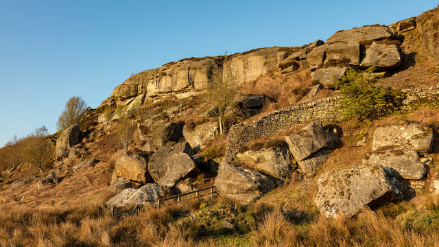 Rothley Crags, Rothley, Northumberland, England, UK. bathed in evening sunlight.